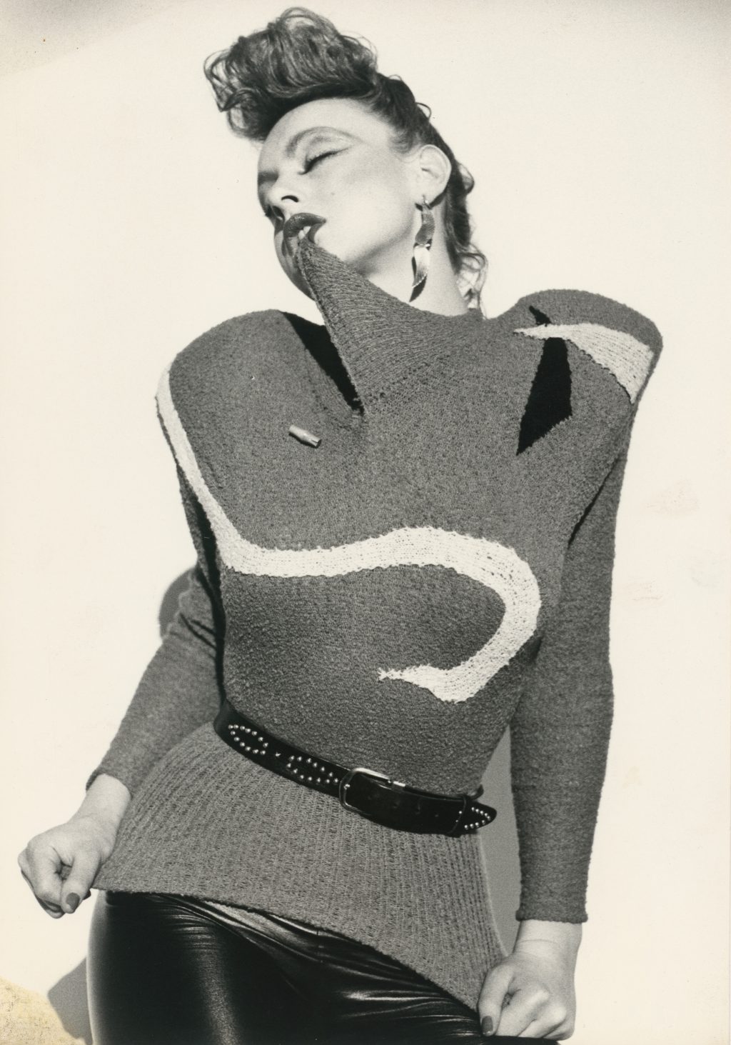 Women biting 80s knit swetaer, Fashion Design Advertisment by Claudia Skoda, from circa 1978